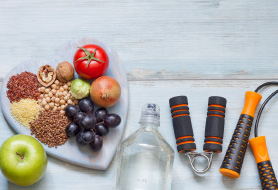 a collection of healthy food and exercise equipment