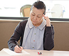 A senior woman thinking and writing
