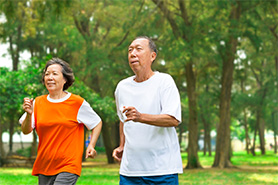 a senior couple brisk walking