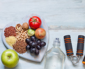 an assortment of healthy food choices and exercise equipment