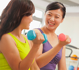 two women lifting weights